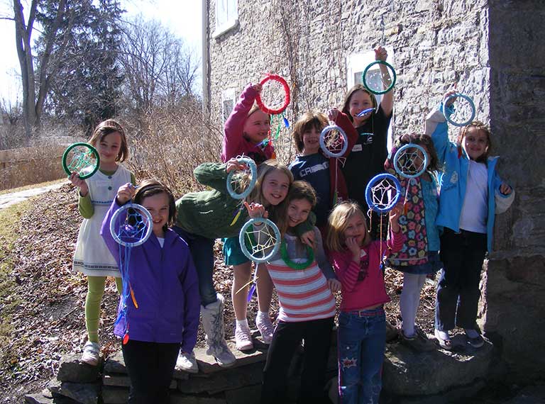 School group holding dream catchers created in a Hutchison House Museum program