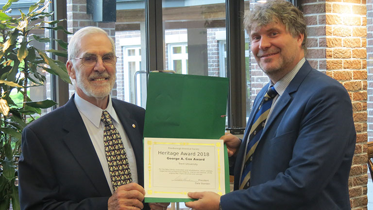 Michael Eamon (right) receives George A. Cox Award to Trent University from PHS President Dale Standen, June 2019